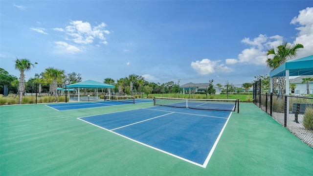 view of tennis court featuring fence
