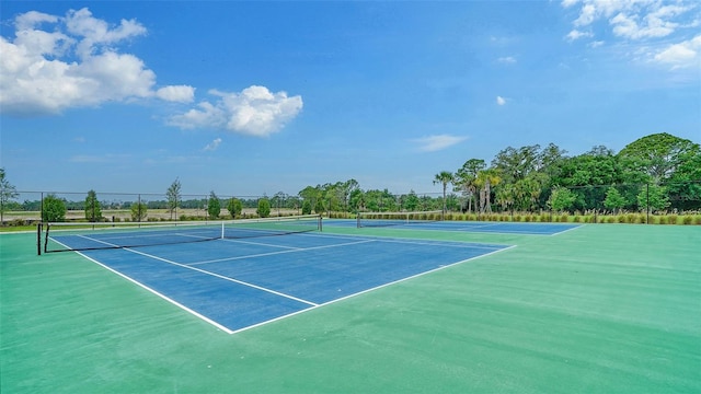 view of tennis court with fence