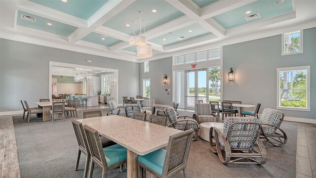 10105 Canaveral Cir, Sarasota, FL 34241 - dining area featuring a towering ceiling, healthy amount of natural light, coffered ceiling, beam ceiling, and baseboards