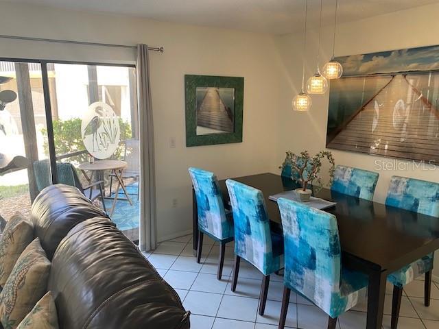 6157 E Midnight Pass Rd Unit B51, Sarasota, FL 34242 - dining area featuring light tile patterned floors