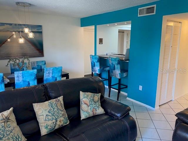 6157 E Midnight Pass Rd Unit B51, Sarasota, FL 34242 - living area with tile patterned floors and a textured ceiling
