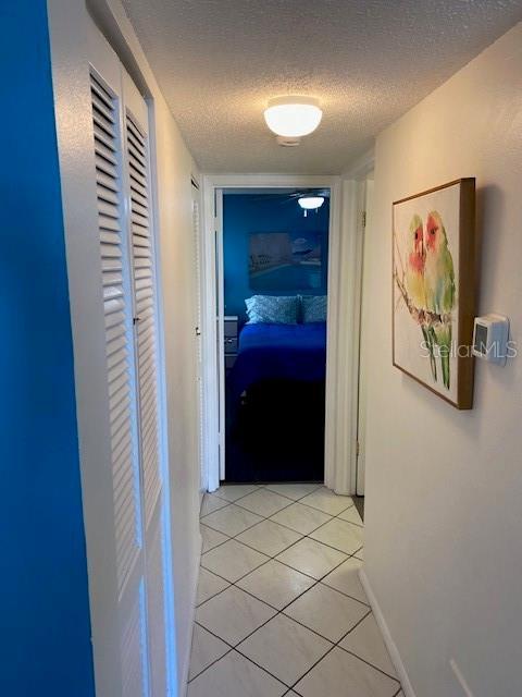 6157 E Midnight Pass Rd Unit B51, Sarasota, FL 34242 - hall featuring a textured ceiling and light tile patterned floors