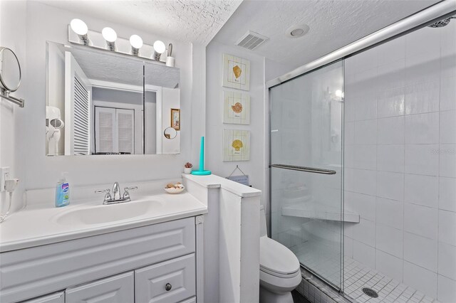 6157 E Midnight Pass Rd Unit B51, Sarasota, FL 34242 - bathroom with a textured ceiling, a shower stall, vanity, and toilet
