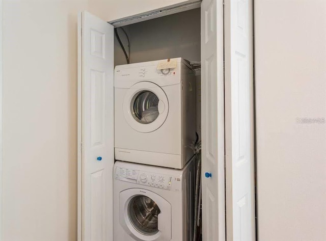 6157 E Midnight Pass Rd Unit B51, Sarasota, FL 34242 - washroom with stacked washer / dryer