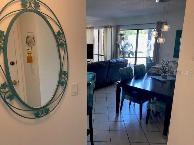 6157 E Midnight Pass Rd Unit B51, Sarasota, FL 34242 - tiled dining room with a textured ceiling