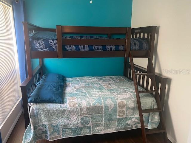 6157 E Midnight Pass Rd Unit B51, Sarasota, FL 34242 - bedroom with wood finished floors and baseboards