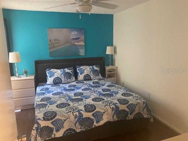 6157 E Midnight Pass Rd Unit B51, Sarasota, FL 34242 - bedroom featuring a ceiling fan and wood finished floors