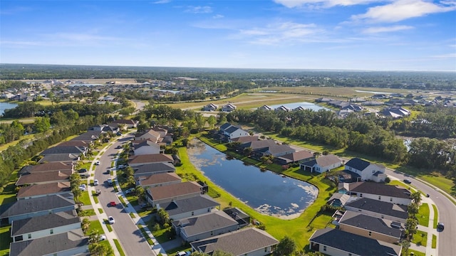 bird's eye view featuring a residential view and a water view