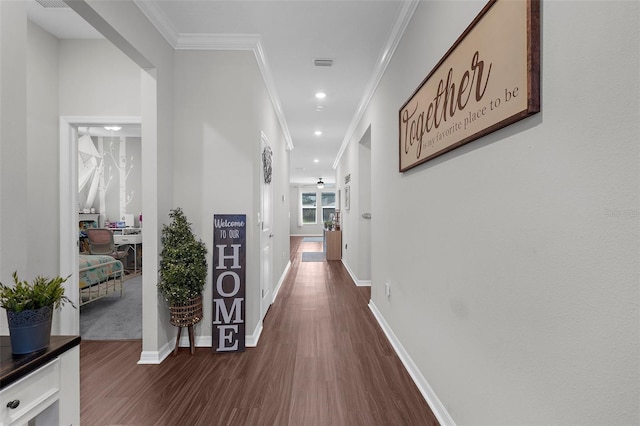 corridor featuring recessed lighting, dark wood-style floors, visible vents, crown molding, and baseboards