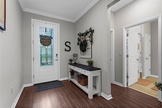 foyer with baseboards, crown molding, and dark wood-style floors