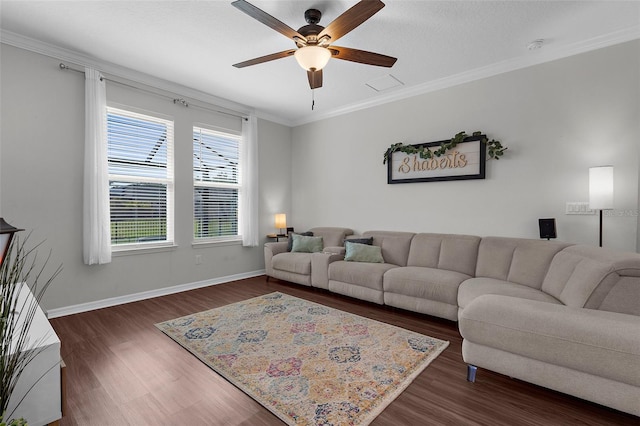living room with dark wood-type flooring, ceiling fan, baseboards, and ornamental molding