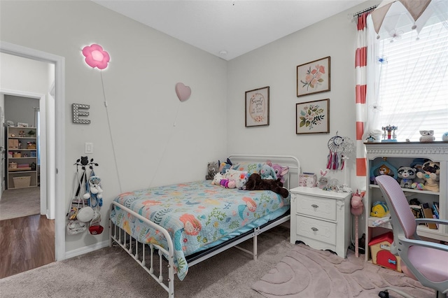 bedroom featuring baseboards and light colored carpet