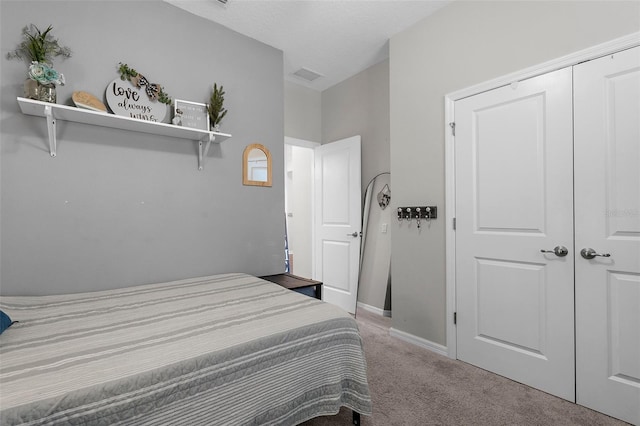 bedroom with carpet, visible vents, and baseboards