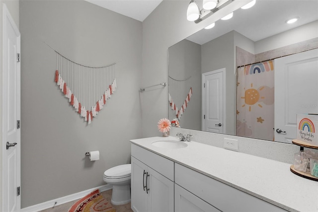 bathroom featuring baseboards, vanity, curtained shower, and toilet