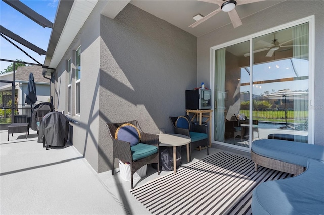 view of patio / terrace featuring a lanai and a ceiling fan