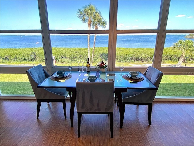 4800 Gulf Of Mexico Dr Unit 205, Longboat Key, FL 34228 - dining area featuring a water view and wood finished floors