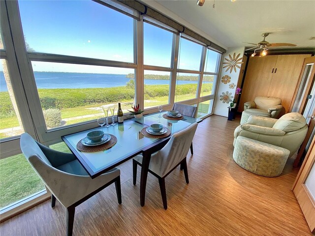 4800 Gulf Of Mexico Dr Unit 205, Longboat Key, FL 34228 - dining area with a water view, plenty of natural light, wood finished floors, and ceiling fan