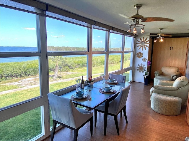4800 Gulf Of Mexico Dr Unit 205, Longboat Key, FL 34228 - dining area featuring a water view, a ceiling fan, and wood finished floors