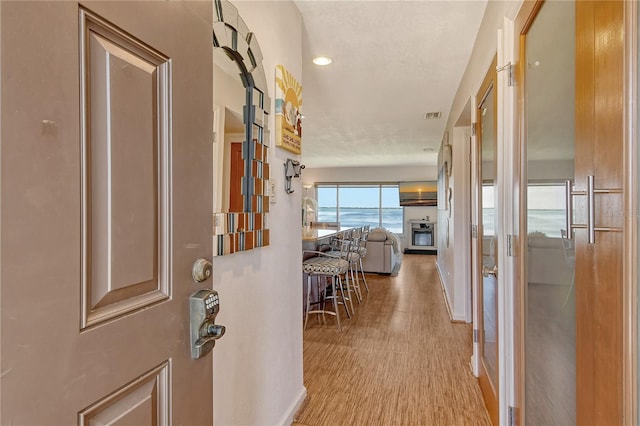4800 Gulf Of Mexico Dr Unit 205, Longboat Key, FL 34228 - hallway featuring wood finished floors and baseboards