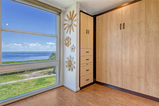 4800 Gulf Of Mexico Dr Unit 205, Longboat Key, FL 34228 - unfurnished room featuring a water view and light wood-style flooring