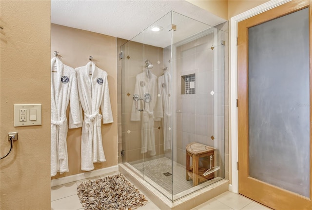 4800 Gulf Of Mexico Dr Unit 205, Longboat Key, FL 34228 - bathroom with tile patterned floors, a stall shower, and a textured ceiling