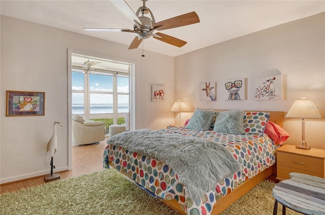 4800 Gulf Of Mexico Dr Unit 205, Longboat Key, FL 34228 - bedroom featuring wood finished floors, a water view, and ceiling fan