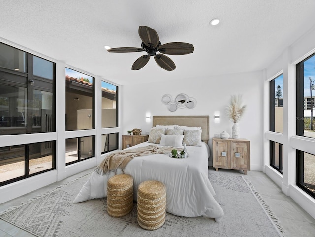 bedroom featuring marble finish floors, a textured ceiling, a ceiling fan, and recessed lighting
