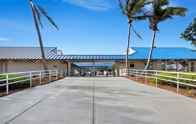 view of property with fence, driveway, and a carport