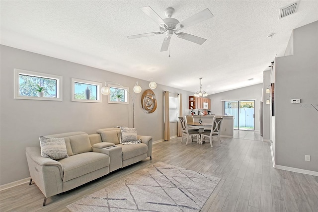 living area with a textured ceiling and baseboards