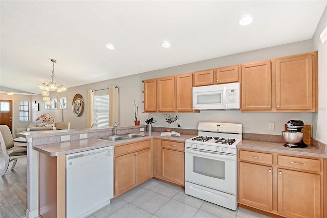 kitchen with a peninsula, light brown cabinetry, a sink, open floor plan, and white appliances