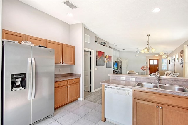 kitchen with a sink, stainless steel refrigerator with ice dispenser, visible vents, dishwasher, and a chandelier