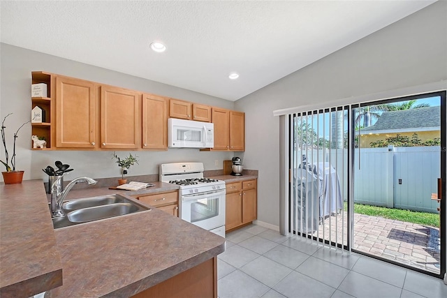 kitchen with lofted ceiling, light tile patterned floors, white appliances, a sink, and open shelves