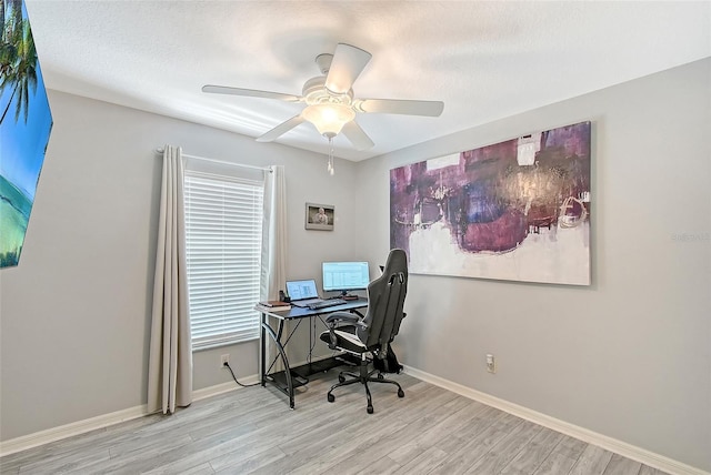 office featuring baseboards, wood finished floors, and a ceiling fan