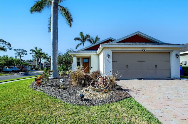 single story home featuring an attached garage, stucco siding, decorative driveway, and a front lawn