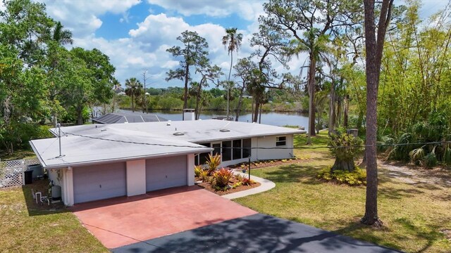 4311 52nd St E, Bradenton, FL 34208 - view of front of house featuring a water view, driveway, and a front yard
