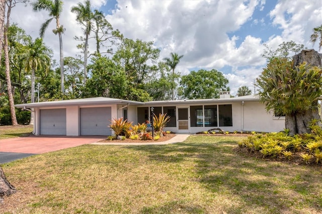 4311 52nd St E, Bradenton, FL 34208 - ranch-style home with an attached garage, a front lawn, stucco siding, and driveway