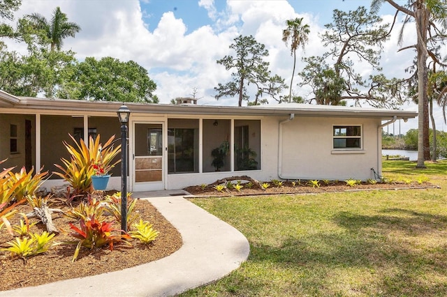4311 52nd St E, Bradenton, FL 34208 - back of house featuring a lawn, a water view, and stucco siding