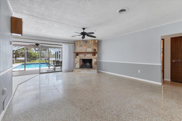 4311 52nd St E, Bradenton, FL 34208 - unfurnished living room featuring visible vents, ceiling fan, a sunroom, a textured ceiling, and speckled floor