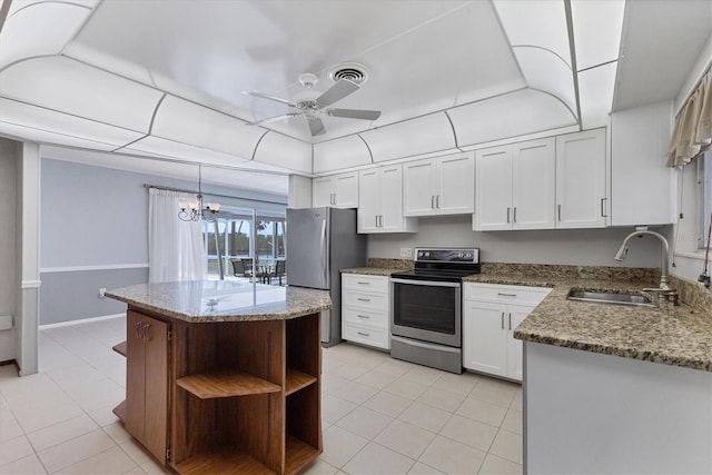 4311 52nd St E, Bradenton, FL 34208 - kitchen with open shelves, a sink, ceiling fan with notable chandelier, stainless steel appliances, and light tile patterned flooring
