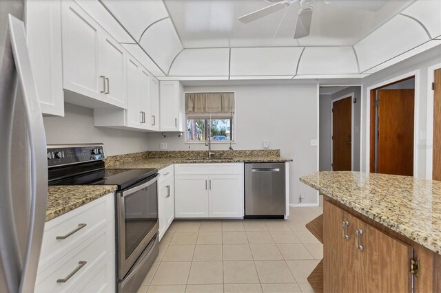 4311 52nd St E, Bradenton, FL 34208 - kitchen with a ceiling fan, a sink, light tile patterned floors, stainless steel appliances, and white cabinetry