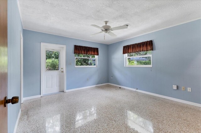 4311 52nd St E, Bradenton, FL 34208 - empty room with a textured ceiling, baseboards, ceiling fan, and speckled floor