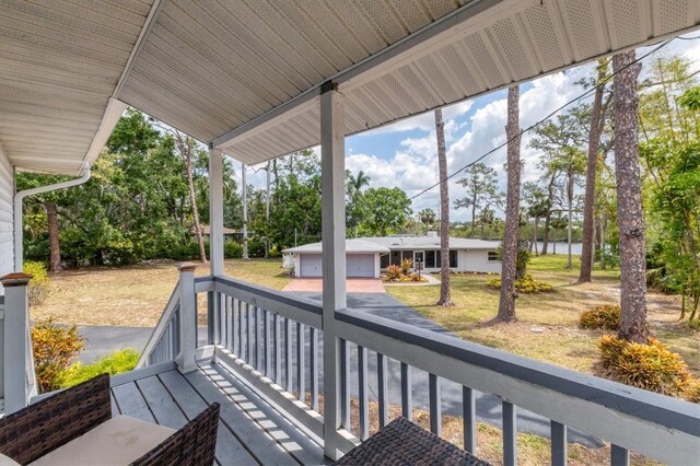 4311 52nd St E, Bradenton, FL 34208 - wooden terrace with a garage and a water view