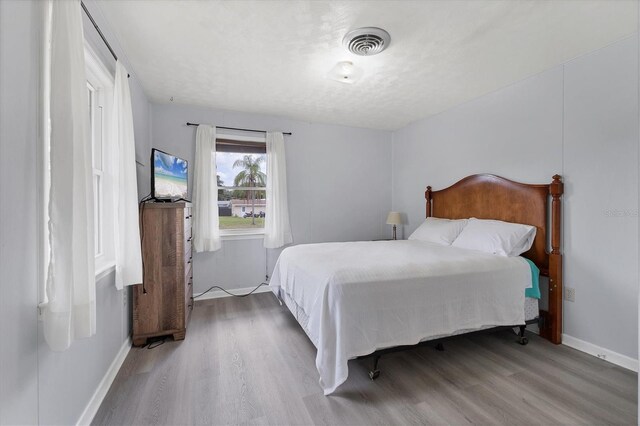 4311 52nd St E, Bradenton, FL 34208 - bedroom with baseboards, wood finished floors, and visible vents