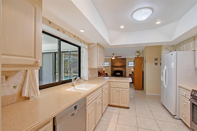 4609 Talbot Pl, Sarasota, FL 34241 - kitchen featuring a fireplace, light countertops, a sink, and appliances with stainless steel finishes