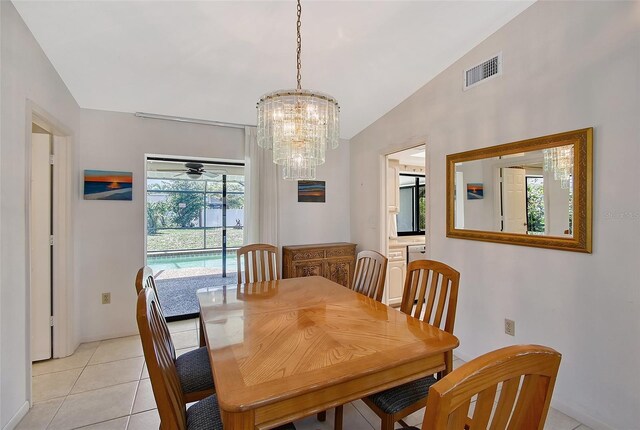 4609 Talbot Pl, Sarasota, FL 34241 - dining space with ceiling fan with notable chandelier, vaulted ceiling, visible vents, and light tile patterned floors