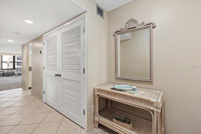 5780 Midnight Pass Rd Unit 410, Sarasota, FL 34242 - corridor with light tile patterned flooring, baseboards, visible vents, and recessed lighting