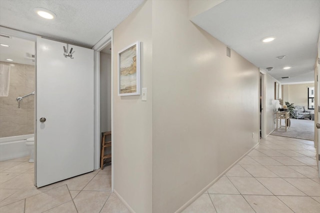 5780 Midnight Pass Rd Unit 410, Sarasota, FL 34242 - hall featuring recessed lighting, a textured ceiling, baseboards, and light tile patterned floors
