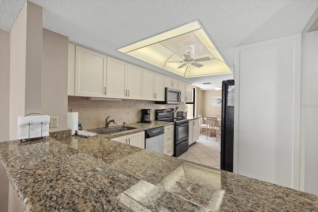 5780 Midnight Pass Rd Unit 410, Sarasota, FL 34242 - kitchen featuring light tile patterned flooring, ceiling fan, a sink, backsplash, and black appliances