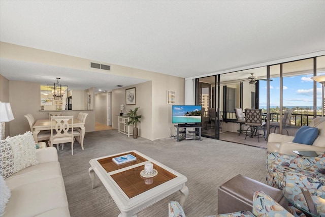 5780 Midnight Pass Rd Unit 410, Sarasota, FL 34242 - living area with carpet floors, visible vents, a wall of windows, and an inviting chandelier