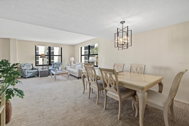 5780 Midnight Pass Rd Unit 410, Sarasota, FL 34242 - dining space featuring a textured ceiling, carpet, and a chandelier